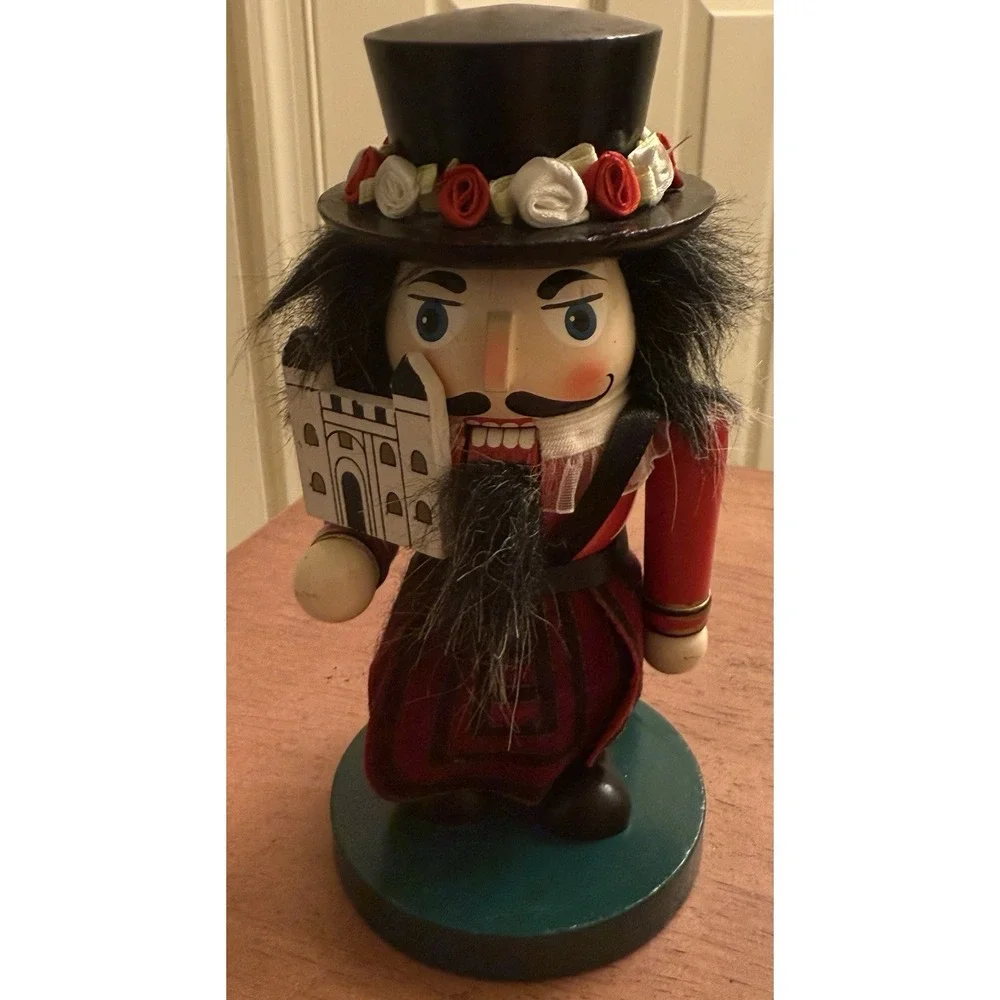 RED STUBBY MULTICOLOR WOODEN NUTCRACKER W/FLOWERED HAT - ENGLISH‎
